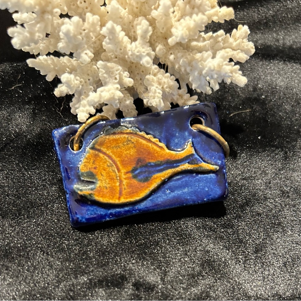 Pretty little ceramic fish with a blue background and little brown fish